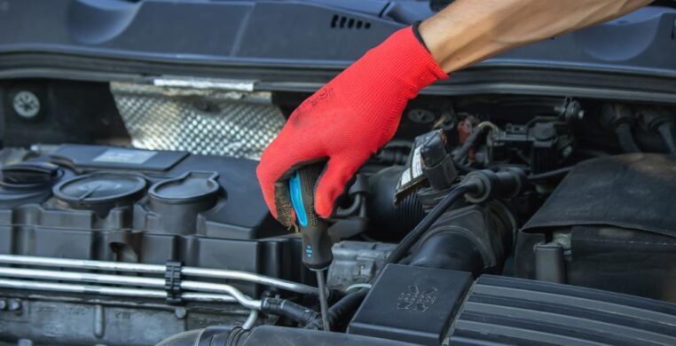 Mechanic working on the engine bay during oil change Nottingham.