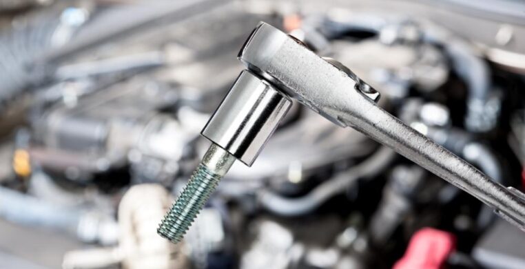 Fuel injector repair and replacement Nottingham — close-up of automotive tools in a professional garage setting.